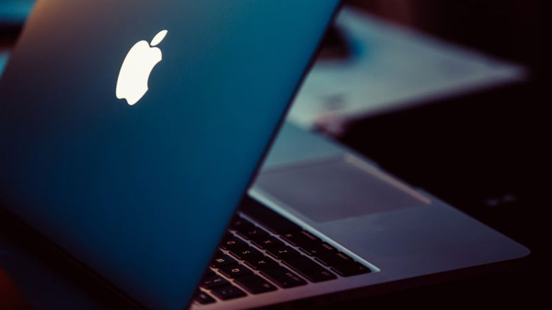 MacBook sitting on desk.