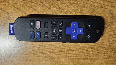 A Roku voice remote laying on its side.