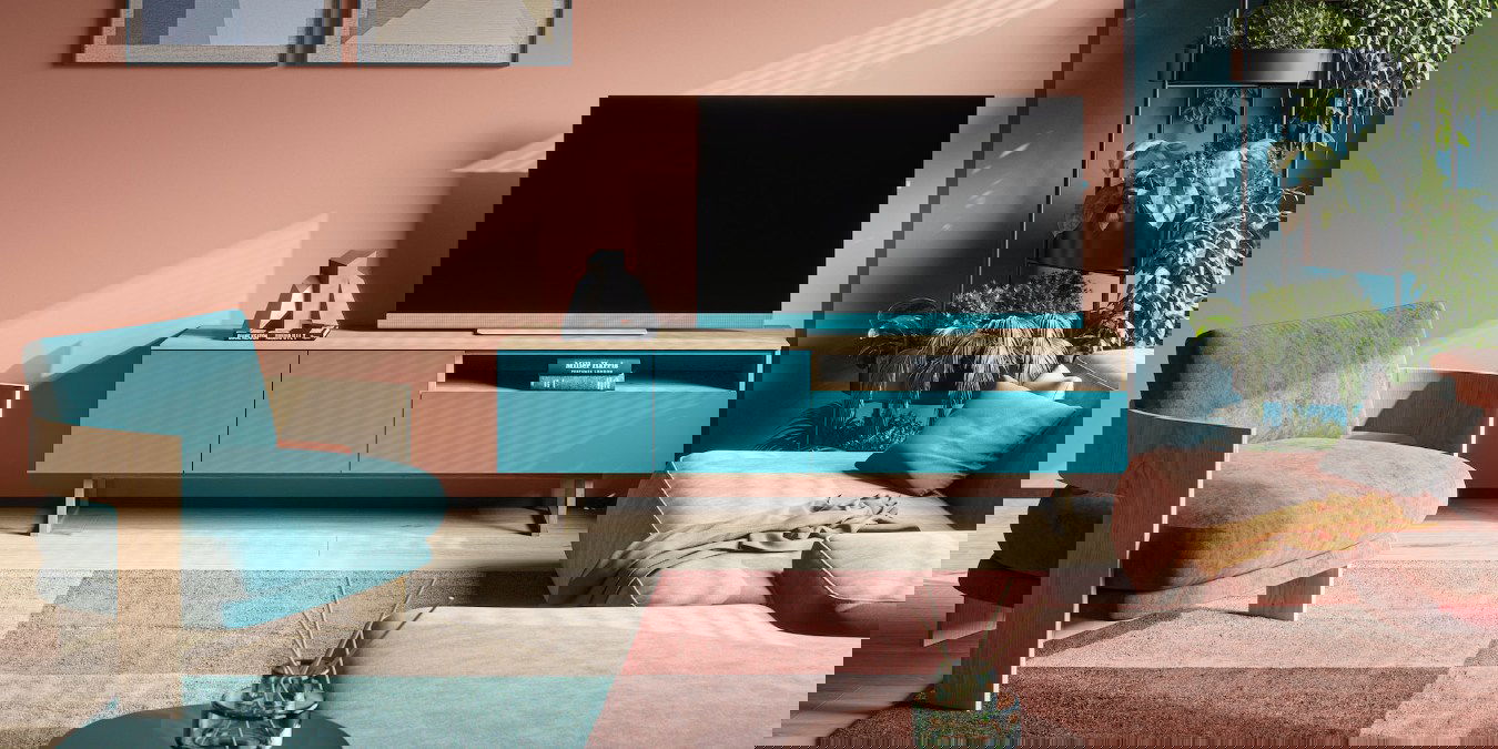 Living room TV setup with blue and pink themed furniture