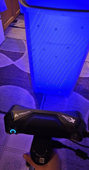 Scanning a trash can with blue lights.