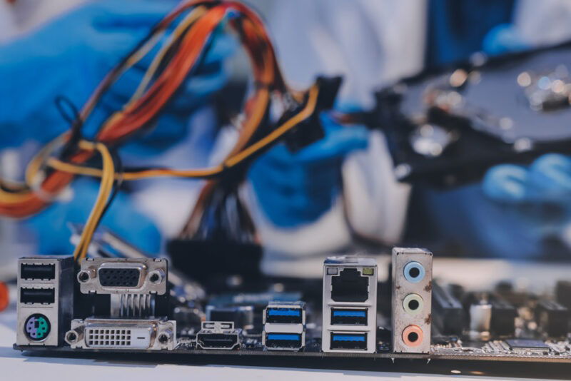 technicians fixing PC motherboard