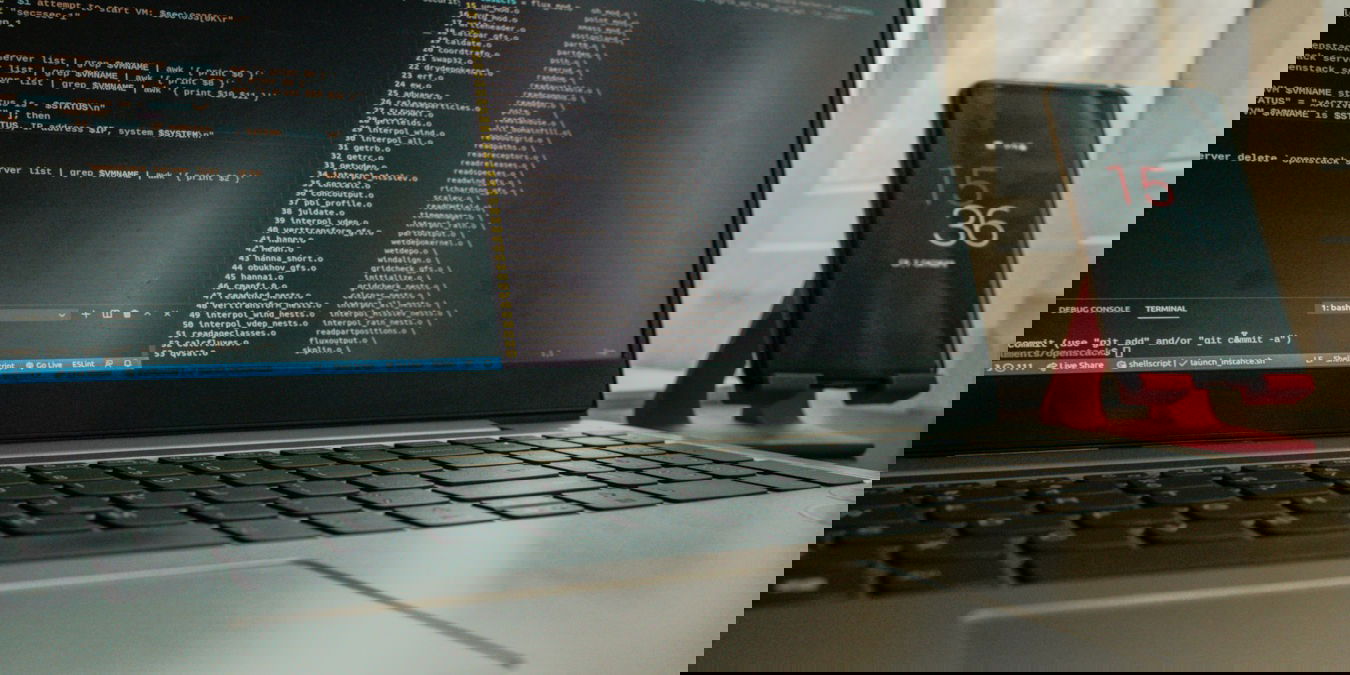 A photograph of a laptop with two terminal windows open.