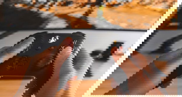 Person playing an Xbox game.