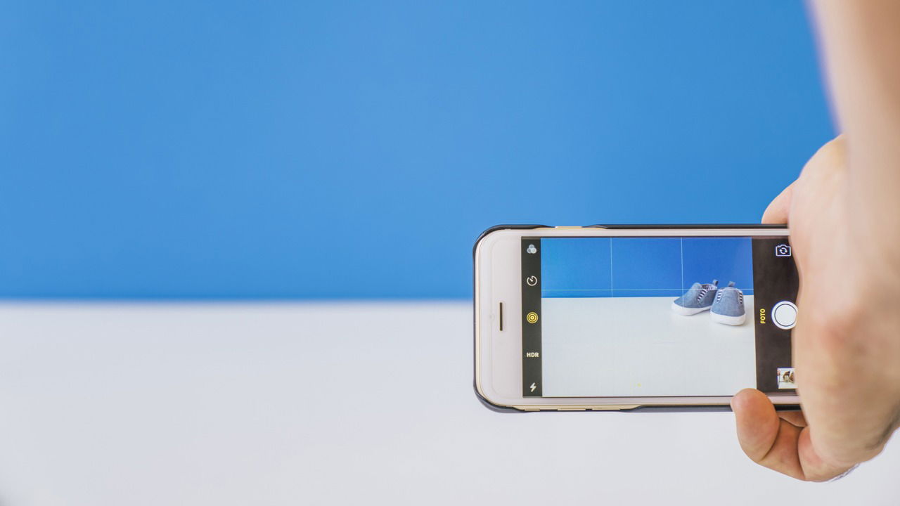Taking picture of shoes with blue background