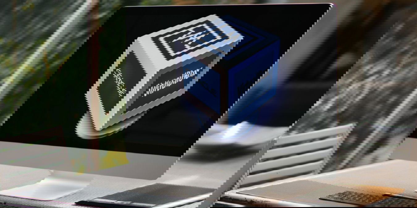 A photograph of a desktop on a gray table.