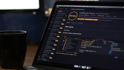 A photograph of a laptop running VSCode.