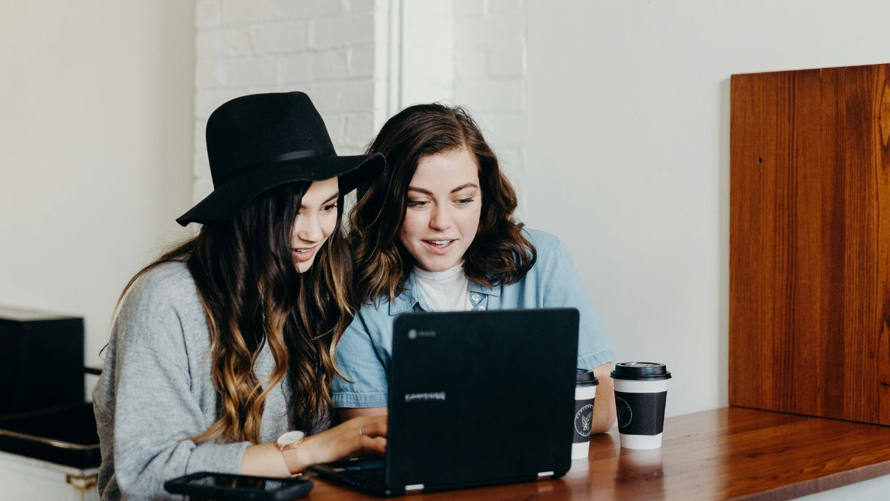 Two women working on a computer